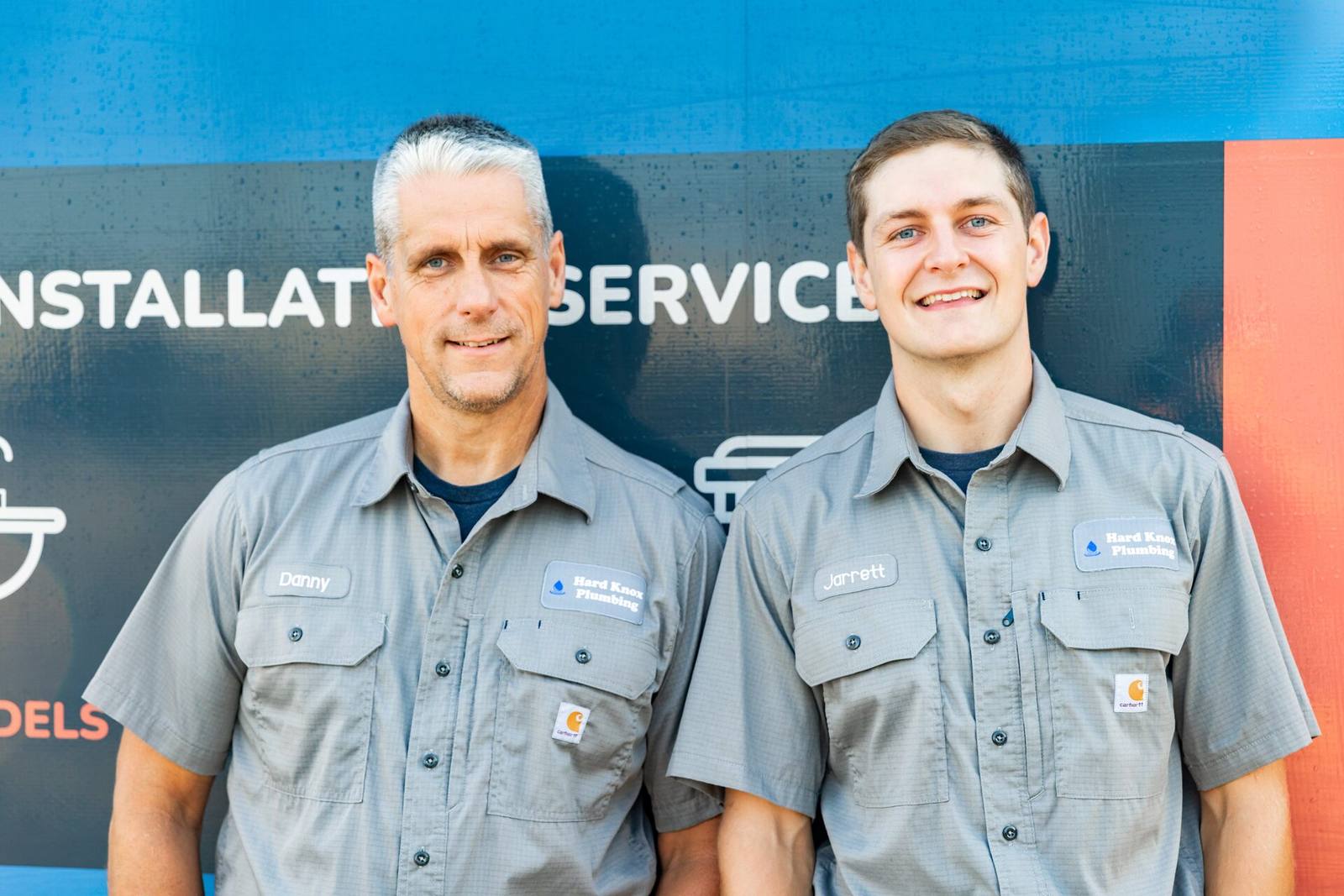 Danny and Jarrett, owners of Hard Knox Plumbing, in front of a service truck in Knoxville, TN