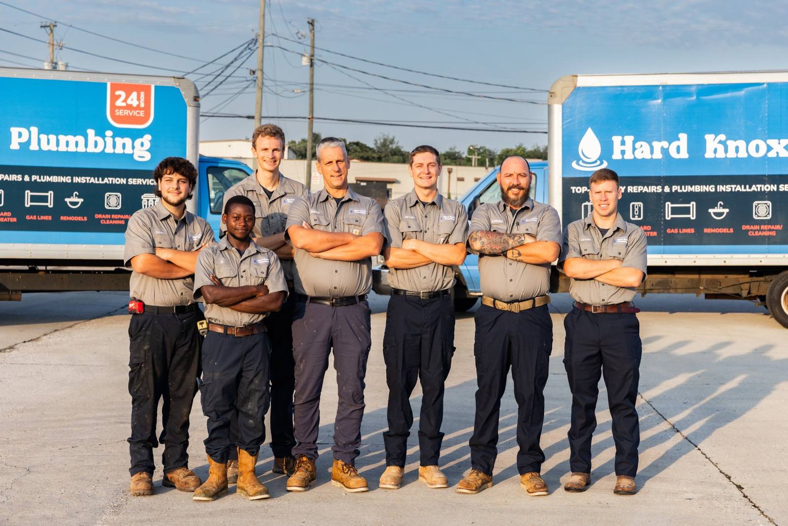 The Hard Knox Plumbing crew outside their Knoxville, TN shop with two service trucks