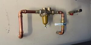 Copper piping and pressure valve used in a home where the plumbing system is damaged