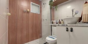 Shower head spraying water, showing good pressure for summer plumbing tips.