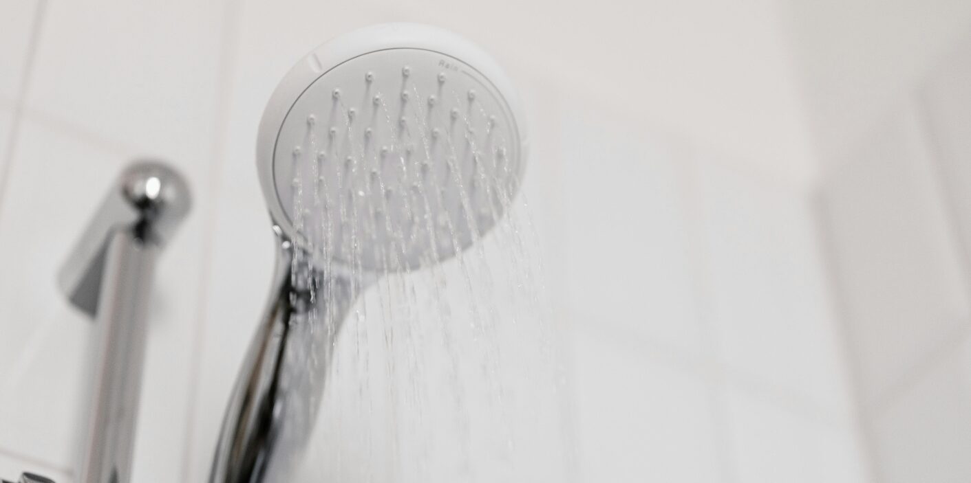 Showerhead with running water — Plumbing Tips for Rental Property Owners in Knoxville.