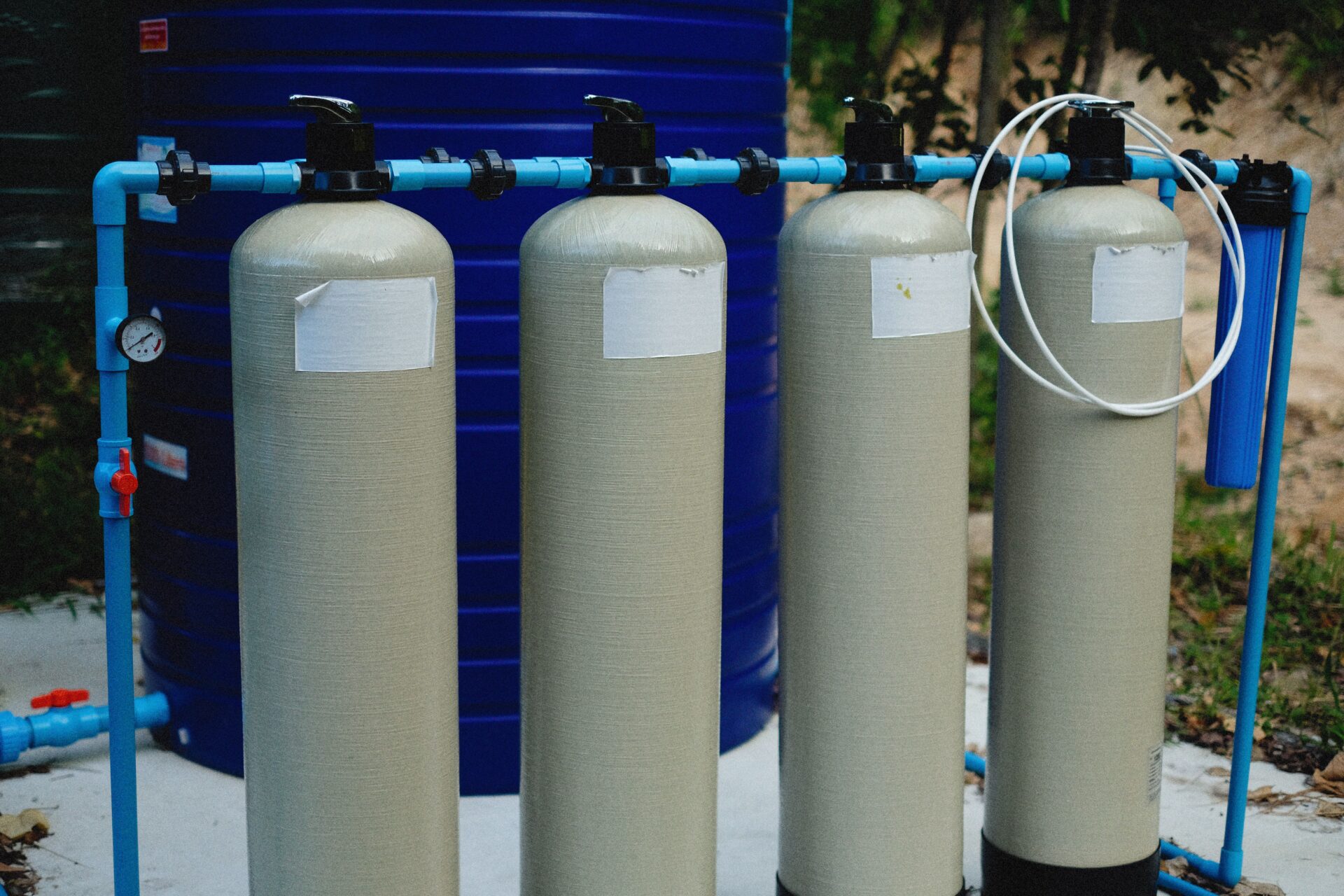 Whole-house water filtration system with multiple tanks and blue PVC piping installed for a Knoxville residence